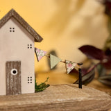 Wooden House With Flag Garland