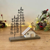 Wooden House On Block With Spiral Trees