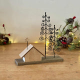 Wooden House On Block With Spiral Trees