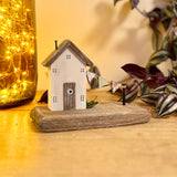 Wooden House With Flag Garland